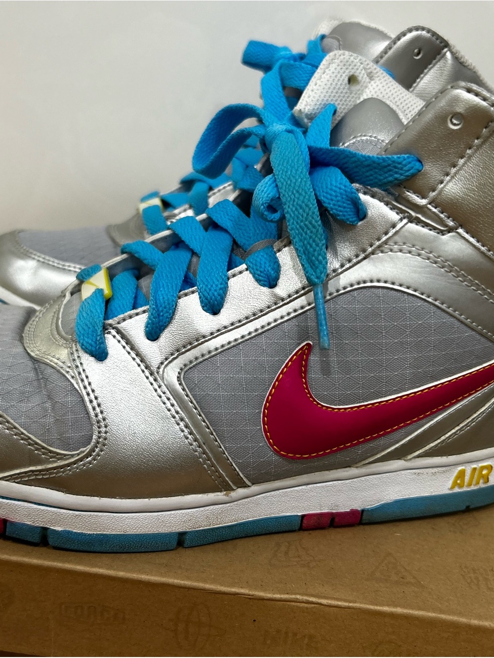 Nike woman’s Silver High-Top Sneakers with Pink Swoosh and Blue Laces
